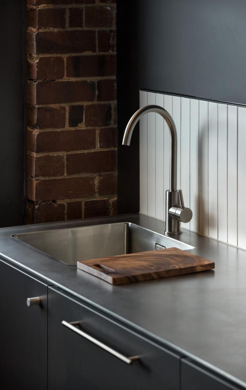 The Chamberson Hotel Dunedin Exterior photo A kitchen sink with a wooden cutting board